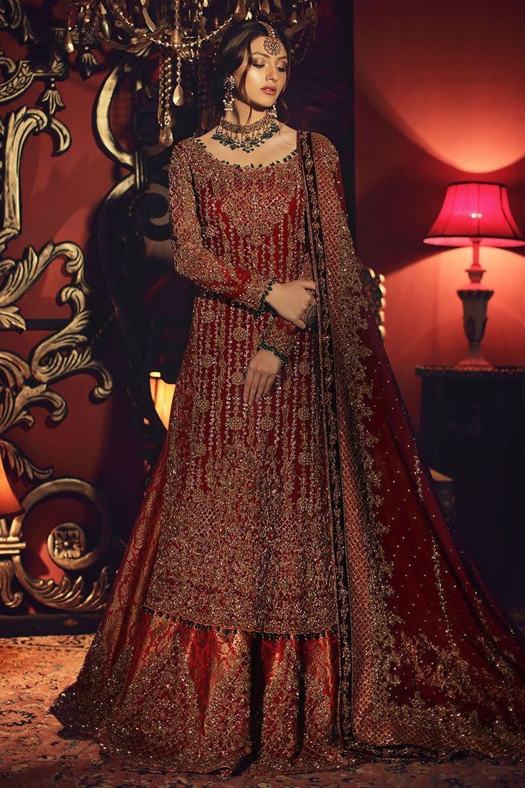 Woman in a traditional embroidered outfit with a decorative background